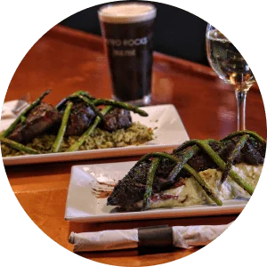 Circle image of Hangar Steak on a bed of mashed potatoes, topped with asparagus.